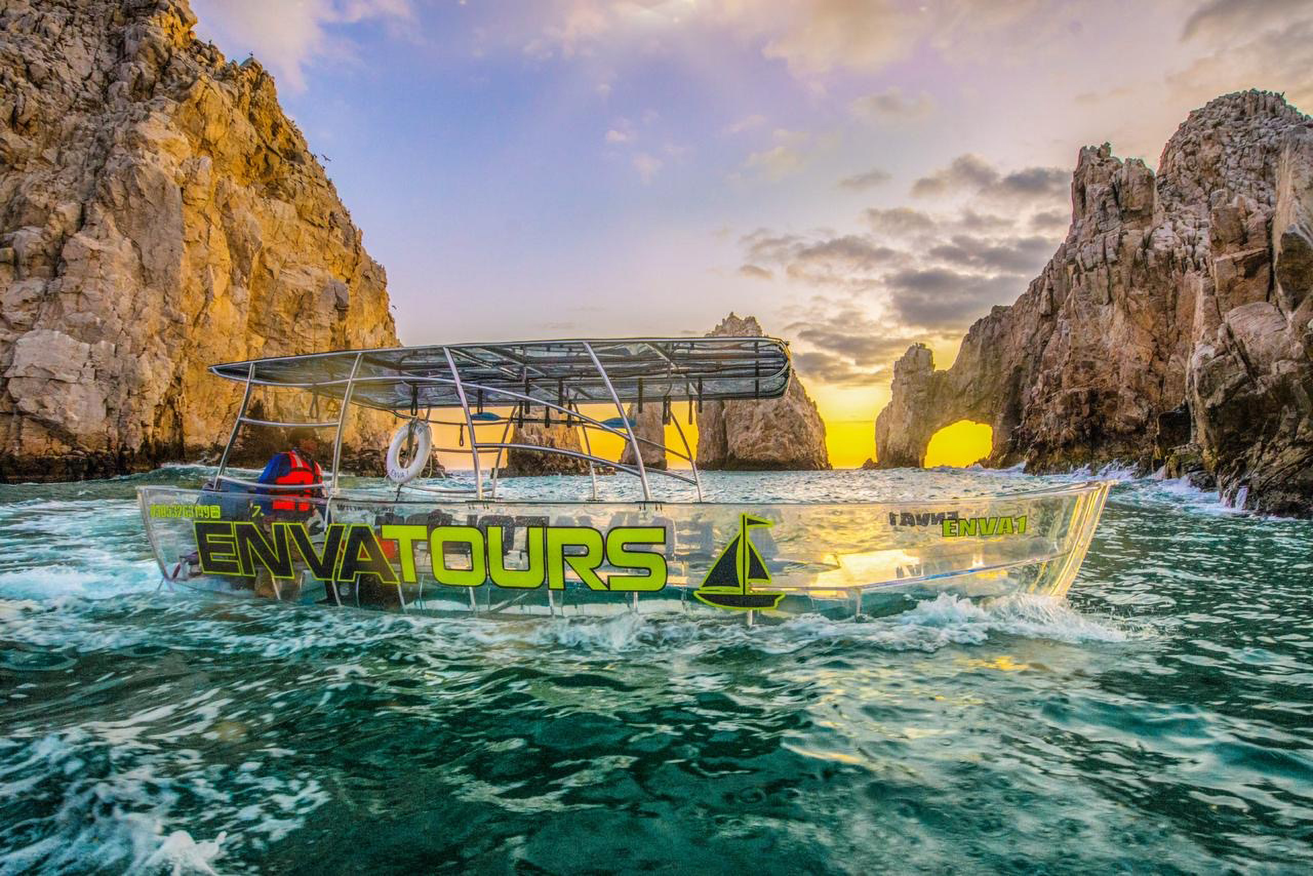 Clear Boat in front of the Land's End Arch in Los Cabos | GlobeQuest Blog